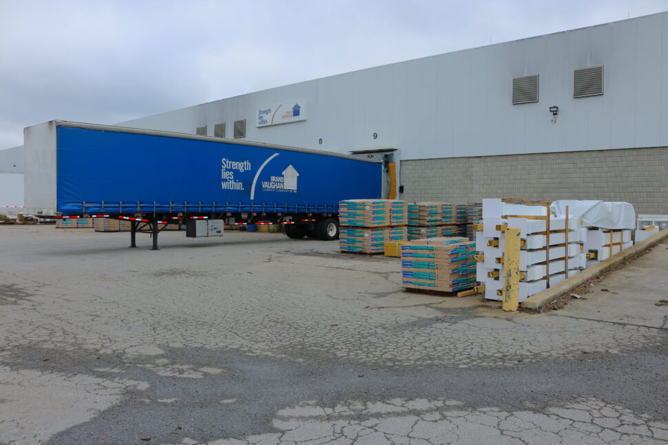 A Brand Vaughan truck is at a warehouse to be loaded with materials