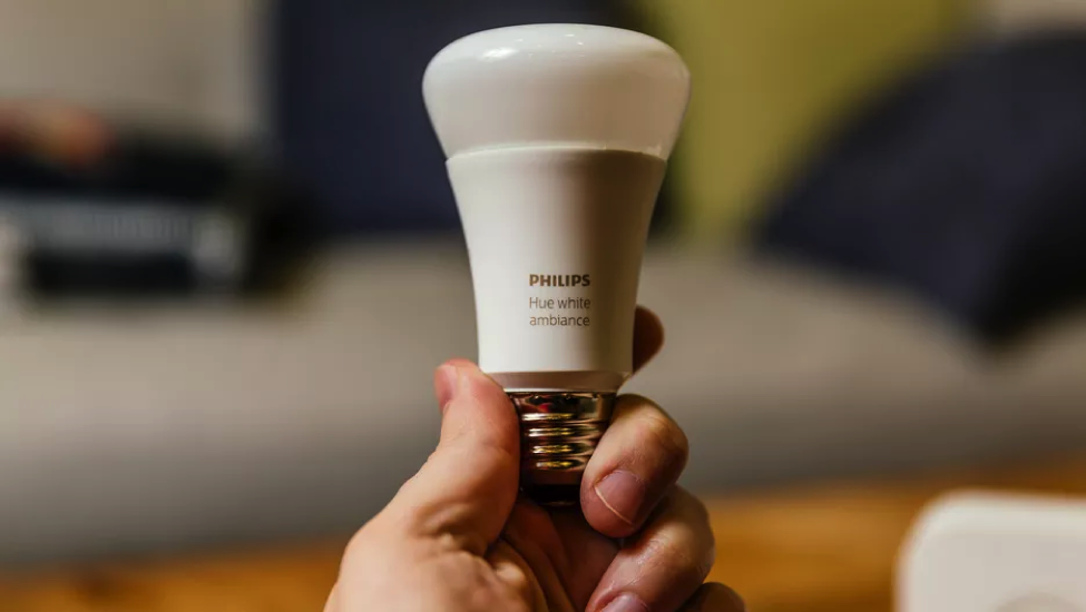 Smart Phillips lightbulb that is being held.