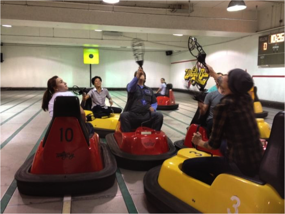 People laughing and having fun while riding bumper cars.